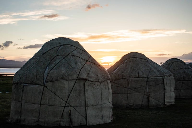 Felt yurts at sunset on the shore of Song-Kol Lake